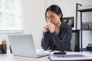 Businesswoman is thinking and is stressed about work.