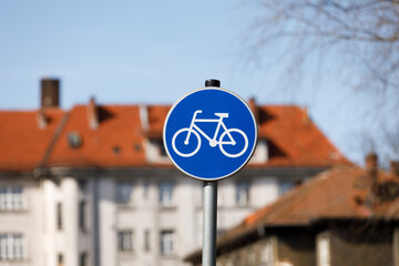 Bicycle sign on street post with the blurred background