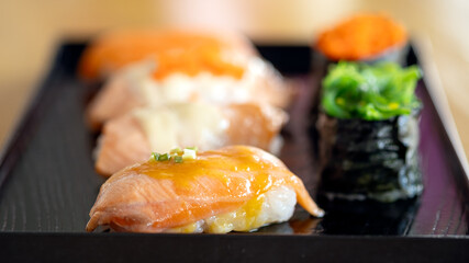 An enticing array of delectable Sushi Set with Salmon and Tobiko on a chic black serving plate
