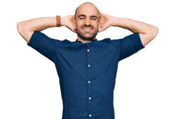 Young hispanic man wearing casual clothes relaxing and stretching, arms and hands behind head and neck smiling happy