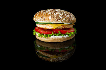 hamburger with chicken on black background