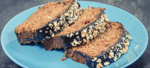 Pastry made of zucchini with nuts and raisin on plate. Delicious dessert