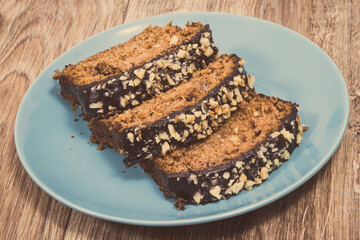 Pastry made of zucchini with nuts and raisin on plate. Delicious dessert. Vintage photo
