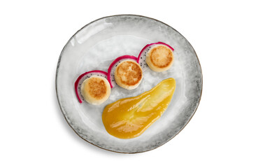 cheesecakes with mango jam on a plate, cut out, top view