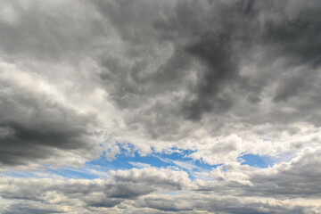 Photo of some white light clouds and cloudy blue sky landscape.