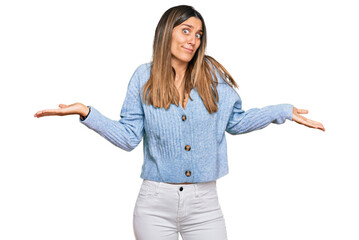 Young woman wearing casual clothes clueless and confused expression with arms and hands raised....