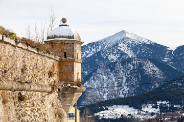 Wall-mounted turret ot the fortified walls of the village of Mont-Louis covered with snow © BreizhAtao