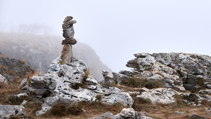 stone balancing art in karst on a foggy day