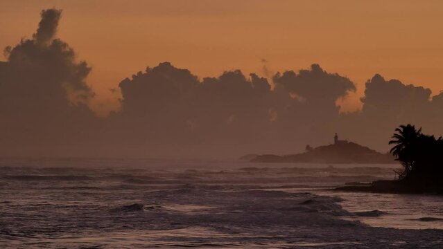 Dramatic lighthouse sunrise at Atlantic coast of Arecibo, Puerto Rico.