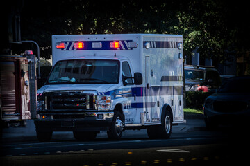 Ambulance with flashing lights on dark day