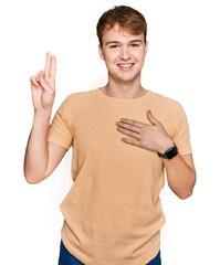 Young caucasian man wearing casual clothes smiling swearing with hand on chest and fingers up,...