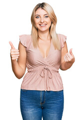 Fototapeta na wymiar Young caucasian woman wearing casual clothes success sign doing positive gesture with hand, thumbs up smiling and happy. cheerful expression and winner gesture.