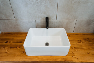 Plumbing fixture tap on wood counter in bathroom with hardwood flooring