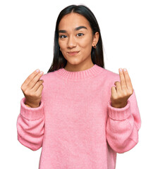 Young asian woman wearing casual winter sweater doing money gesture with hands, asking for salary...