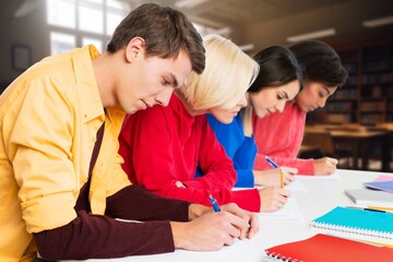 Happy international young students studying together