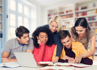 Happy international young students studying together