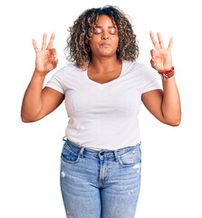 Young african american plus size woman wearing casual clothes relax and smiling with eyes closed doing meditation gesture with fingers. yoga concept.