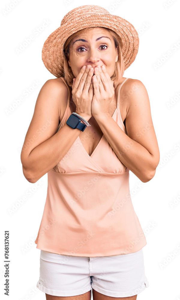 Sticker young blonde woman wearing summer hat laughing and embarrassed giggle covering mouth with hands, gos