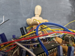 A wooden mannequin fixes an old broken chip.
