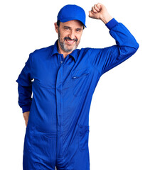 Middle age handsome man wearing mechanic uniform smiling confident touching hair with hand up gesture, posing attractive and fashionable