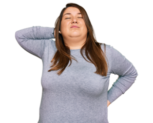 Beautiful brunette plus size woman wearing casual clothes suffering of neck ache injury, touching neck with hand, muscular pain