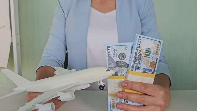 Airplane and money. Plane on the background of USA dollars. The cost of travel, air tickets and flights, financial expenses for vacation