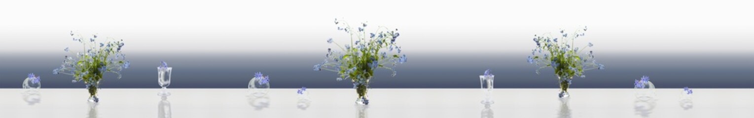 Transparent balls with glass vases and blue flowers