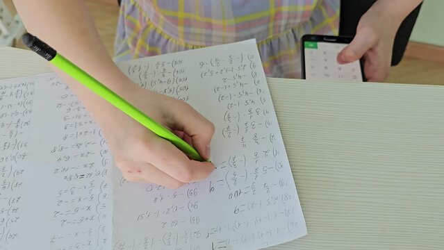 Student is cheating at the test exam with cheat answer written on his smartphone.