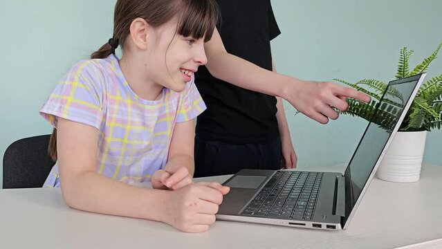 Boy and girl brother and sister with laptop working and students in class. Teenagers working on a laptop