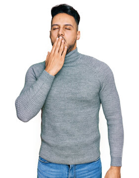 Young arab man wearing casual clothes bored yawning tired covering mouth with hand. restless and sleepiness.