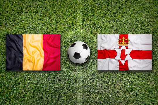 Belgium vs. Northern Ireland flags on soccer field