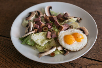 salad with fried egg, mushroom, beef cube 