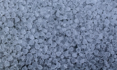 a lot of round crystals of ice precipitation fell in the form of hail after a thunderstorm in spring