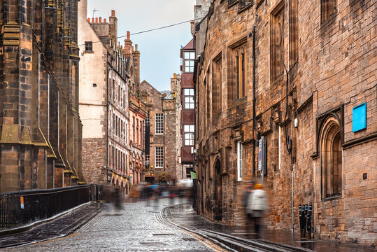 The narrow cobbled street of Castlehill, leading between old buildings towards Edinburgh Castle, Scotland