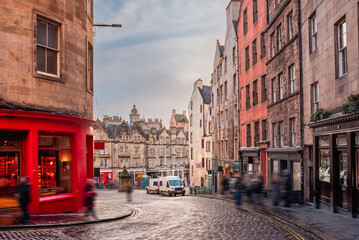 A bright red storefront and old buildings along West Bow and Victoria Street in Edinburgh Old Town,...