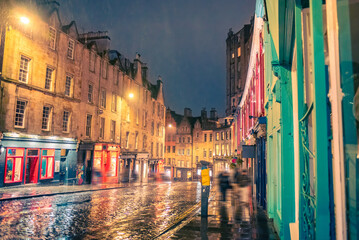 Victoria Street in Edinburgh at night, with lights reflected on the road after rainfall