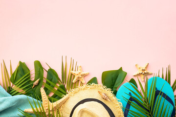 Fototapeta premium Summer flat lay background. Palm leaves, sea shells and summer cloth on pink background.