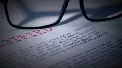Classified document with pair of glasses in damaged film vintage style 