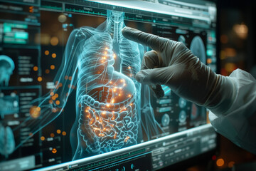 Hand pointing at a computer screen with a picture of human internal organs.