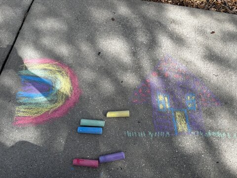 chalk drawing on a sidewalk pink blue yellow and green