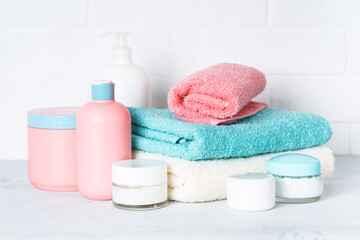 Cosmetic products and clean towels in the bathroom. Spa treatment and beauty.