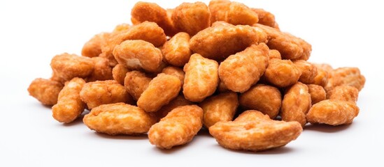 Fototapeta premium A collection of golden-brown chicken nuggets stacked on top of each other on a plain white background. The nuggets are crispy and inviting, ready to be enjoyed as a delicious snack or meal.