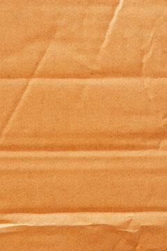 Vertical abstract wrinkled cardboard boxes, cardboard box texture, and background. Detail of brown paper box material.