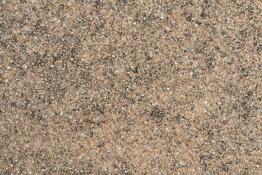 Blank concrete brown rough wall for background. Beautiful brown exposed aggregate wall plastered surface background pattern.