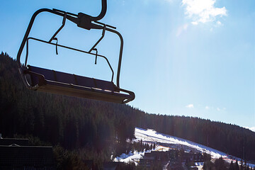 ski lift at a ski resort early in the morning illuminated by the sun. family active recreation