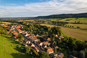 Fototapeta na wymiar Aer ial view of a German village surrounded by meadows, farmland and forest. Thuringia, Germany.