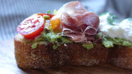 open toast sandwich with ham tomato avocado