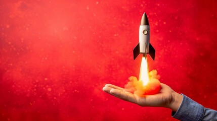 a rocket launch from an open hand isolated on a red background. representing the concept  of business startup and product launch.