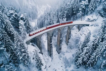 Papier Peint photo Viaduc de Landwasser Majestic Journey Through the Swiss Alps  Aerial View of a Train Traversing the Landwasser Viaduct in Winter