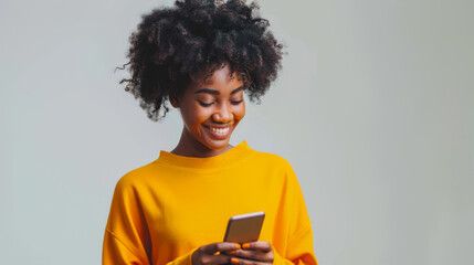 Joyful woman with afro hair using smartphone